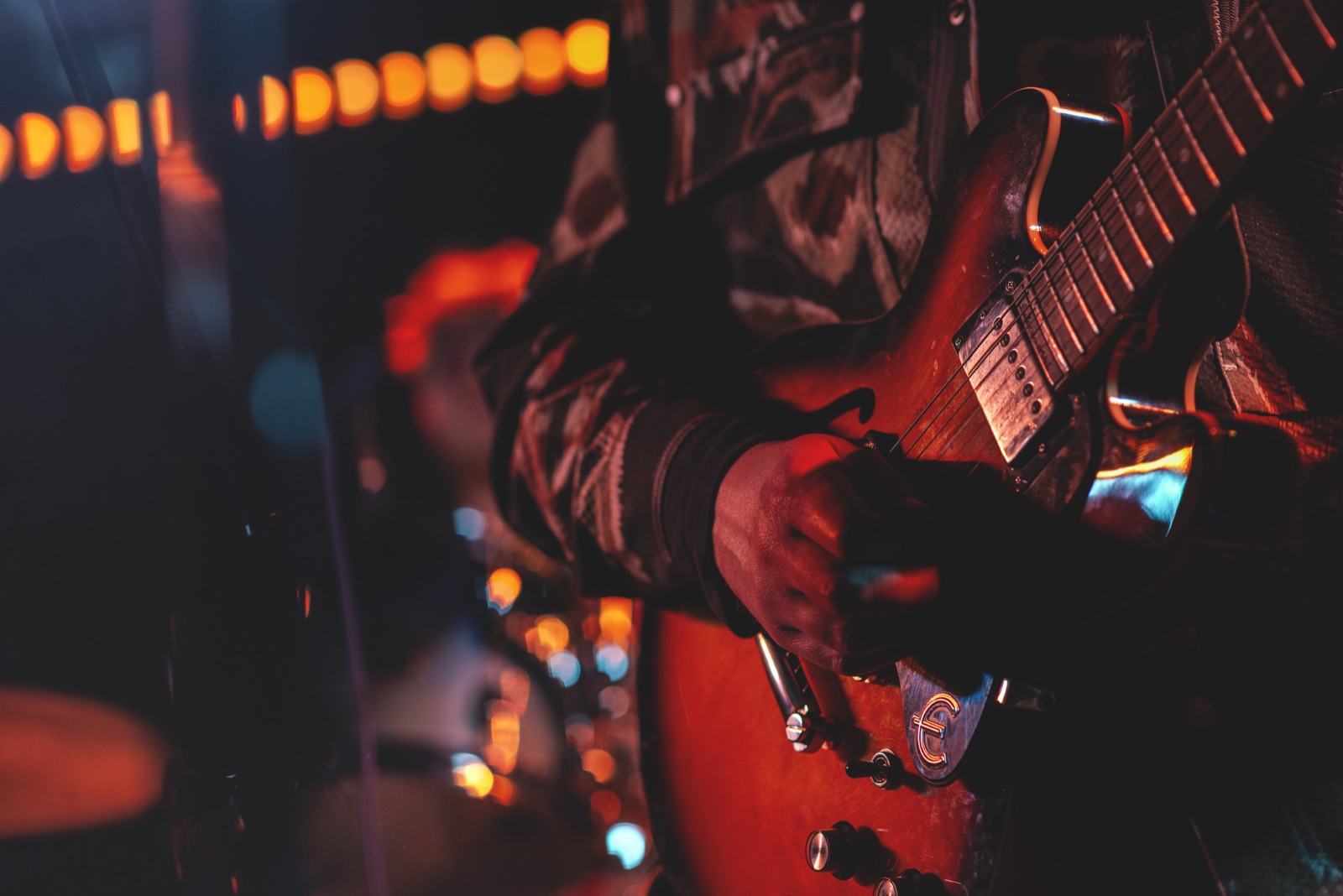 Close-up of Rodaidh Mackay playing guitar during a live performance