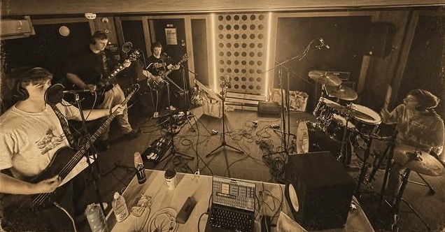 The Apaches recording together in a live room